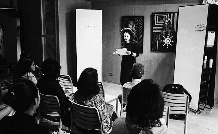 Victoria giving a talk to a seated audience