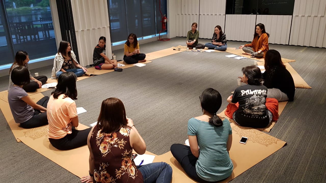 Participants seated in a circle during a guided session