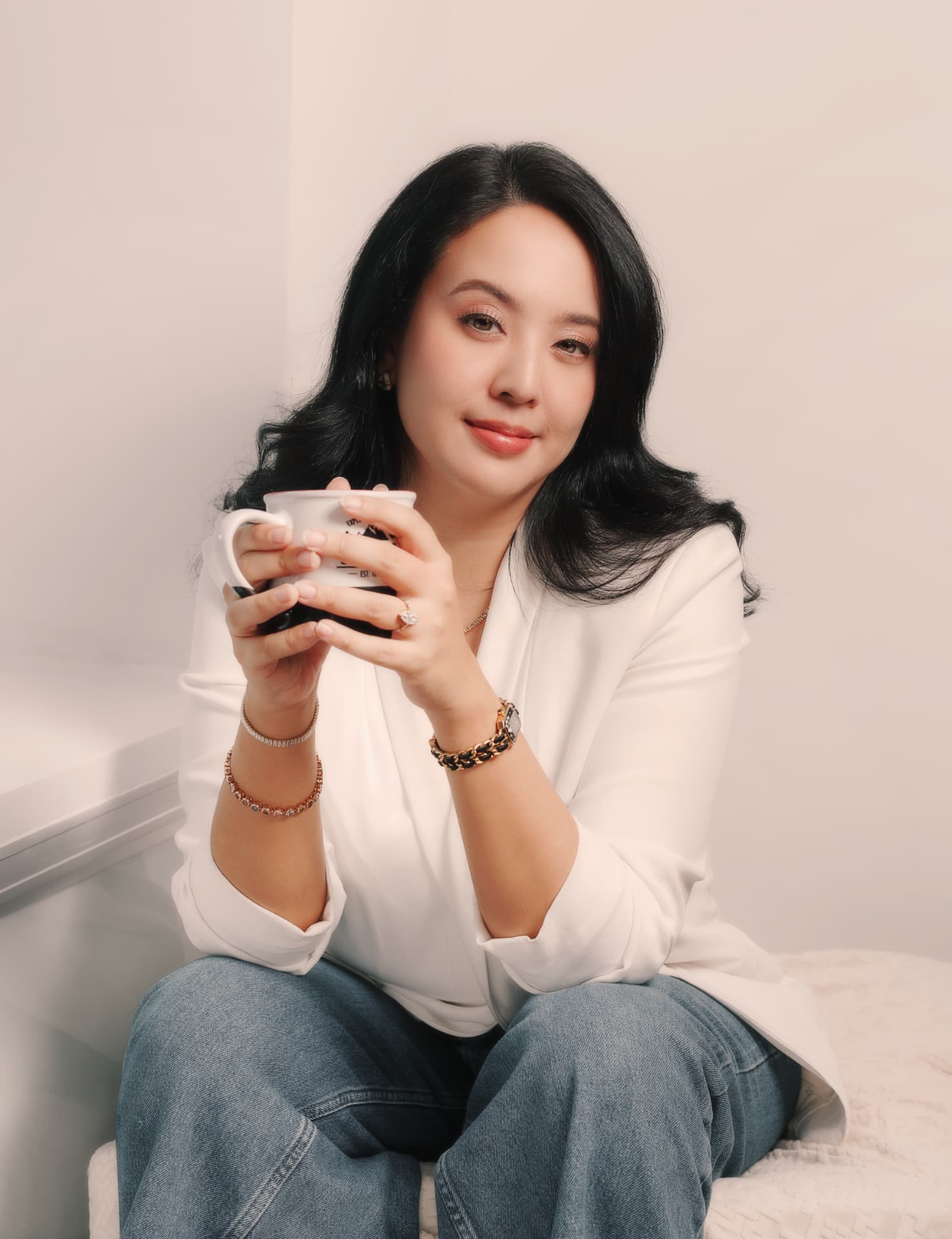 Victoria seated with a cup of coffee